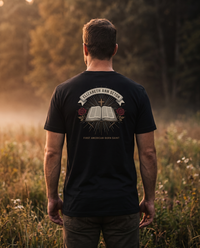 Man seen from behind wearing the Elizabeth Ann Seton shirt: open book, gold cross and red roses, First American-Born Saint &mdash; view 1