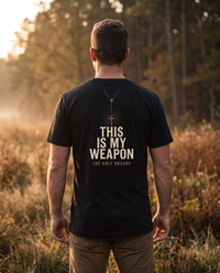 Man seen from behind wearing a tee with a red-beaded rosary and crucifix over This Is My Weapon, The Holy Rosary &mdash; view 1