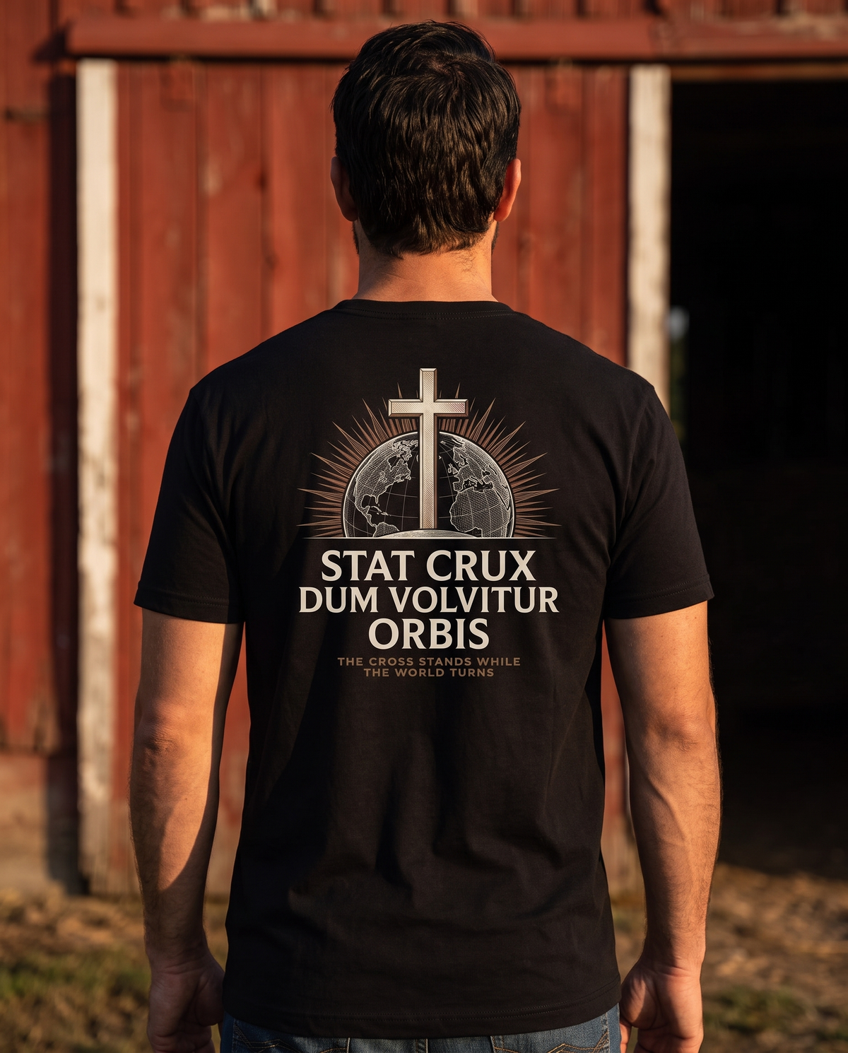 Man seen from behind wearing a tee with a cross on an engraved globe over Stat Crux Dum Volvitur Orbis back print