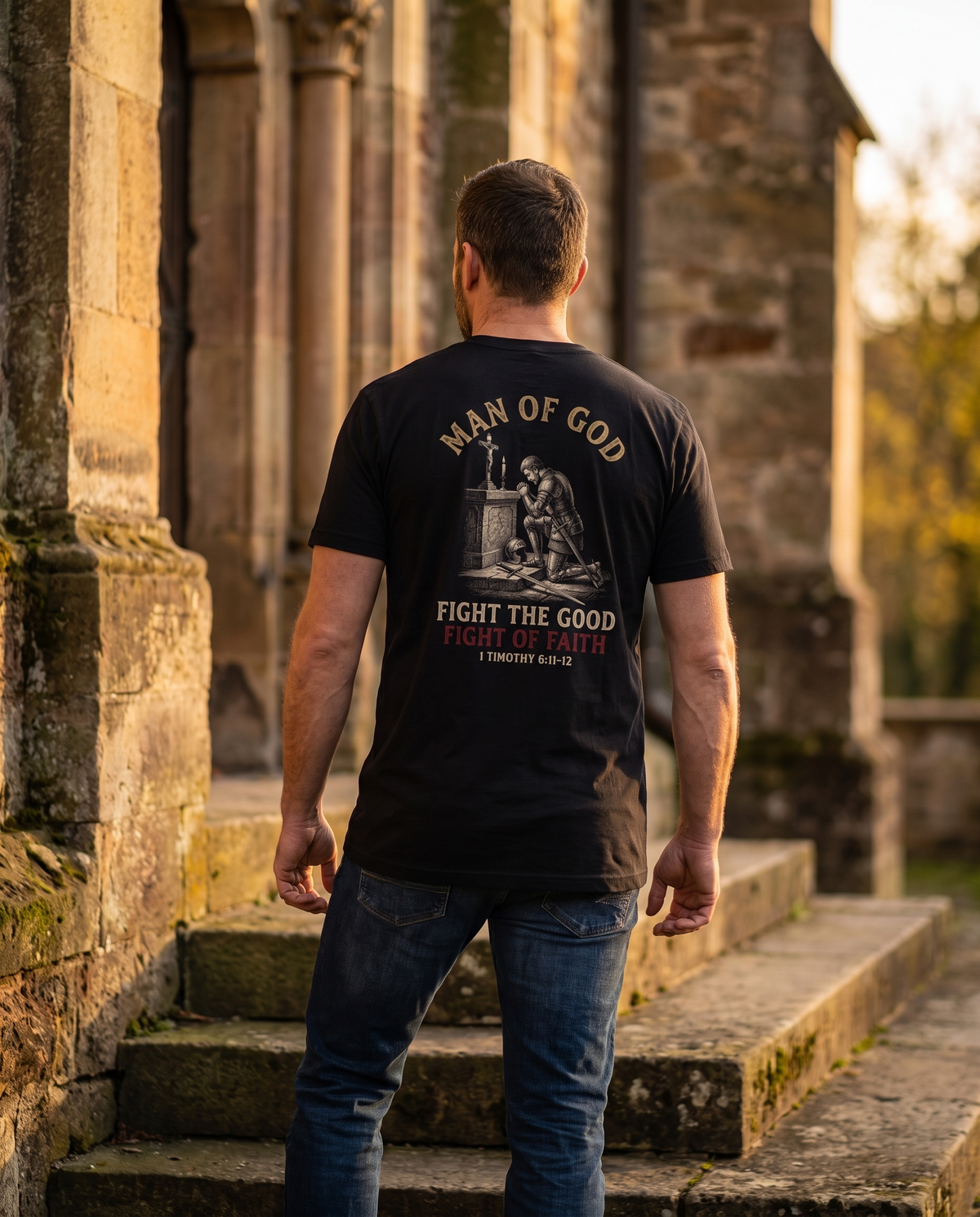 Man seen from behind wearing a Man of God tee: a knight kneeling in prayer before an altar and crucifix