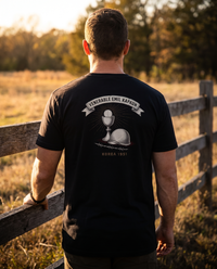 Man seen from behind wearing the Venerable Emil Kapaun shirt: radiant chalice and Host, steel helmet, barbed wire &mdash; view 1