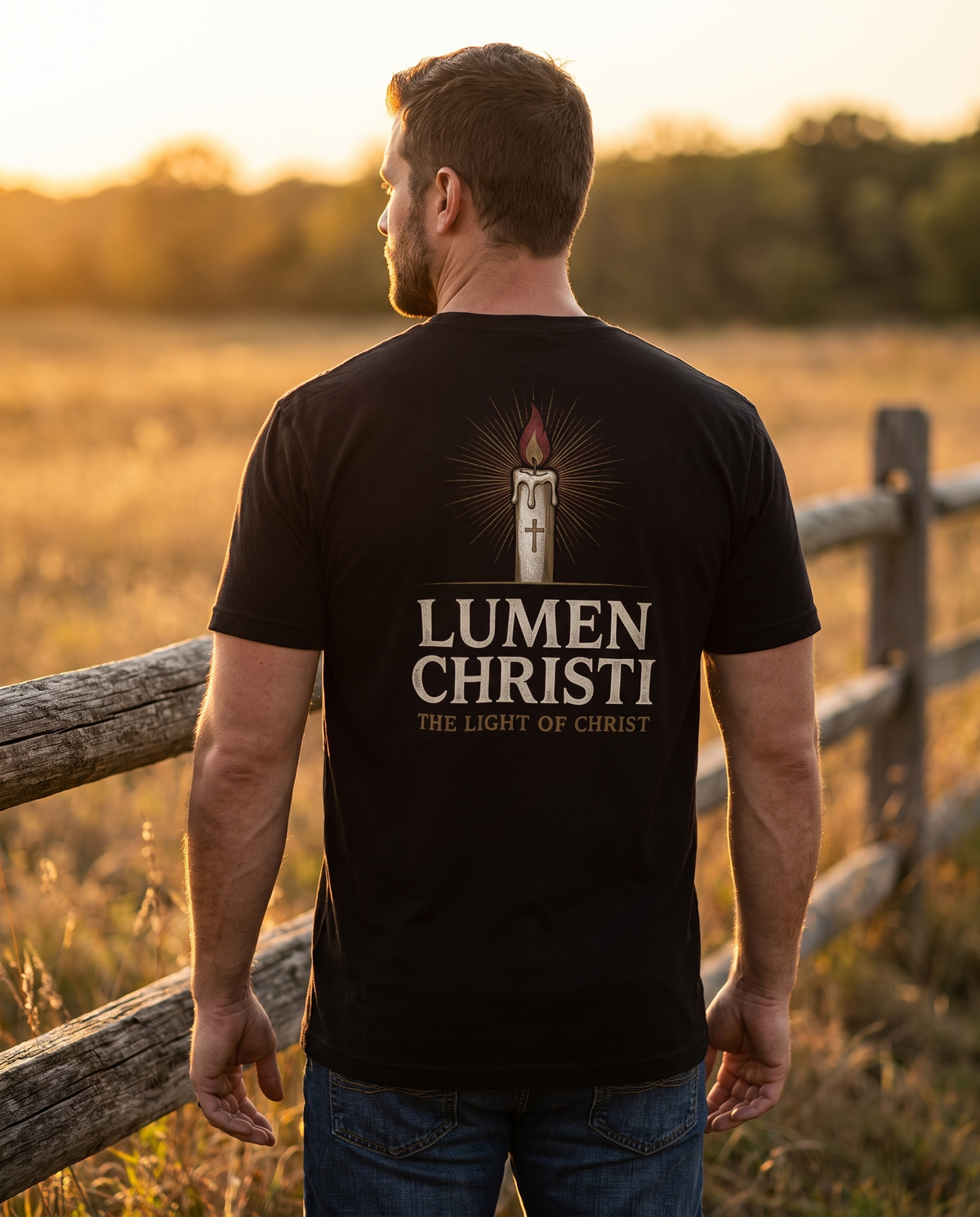 Man seen from behind in a 1765 Apparel tee; back print: a tall candle marked with a cross in gold and red rays, Lumen Christi