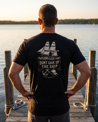 Man seen from behind wearing the Don't Give Up the Ship shirt: engraved brig under sail, banner, anchor, Lake Erie 1813 &mdash; view 1
