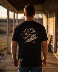 Man seen from behind wearing the We the People shirt: blackletter script, an arc of thirteen stars, quill pen, 1787 &mdash; view 1